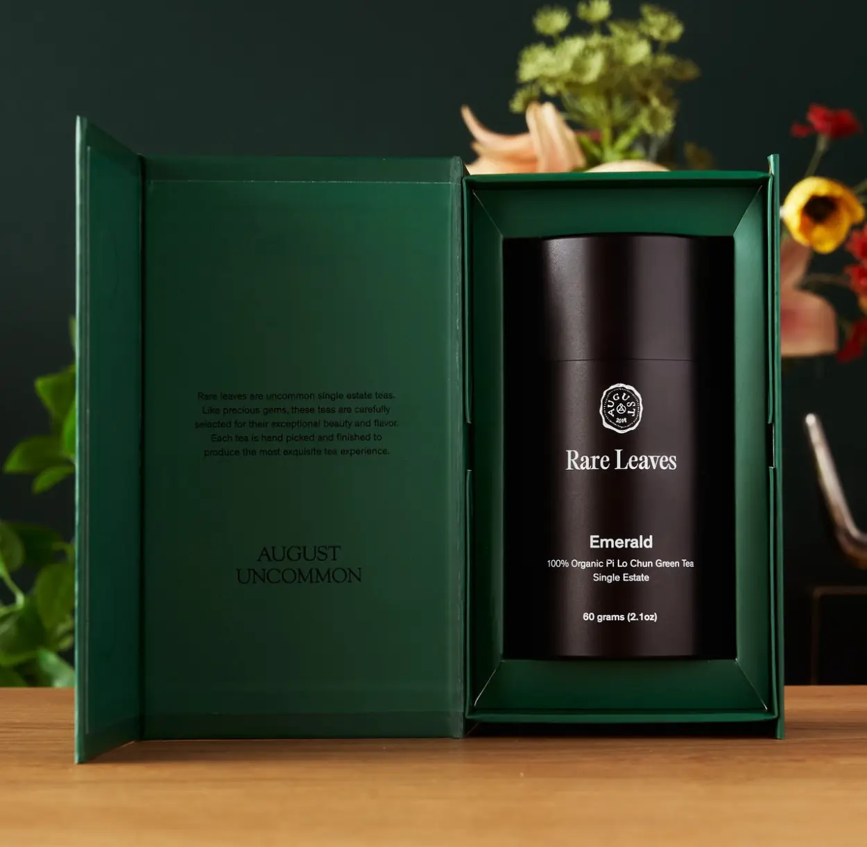 An August Uncommon gift box holding a tin of Rare Leaves Emerald green tea